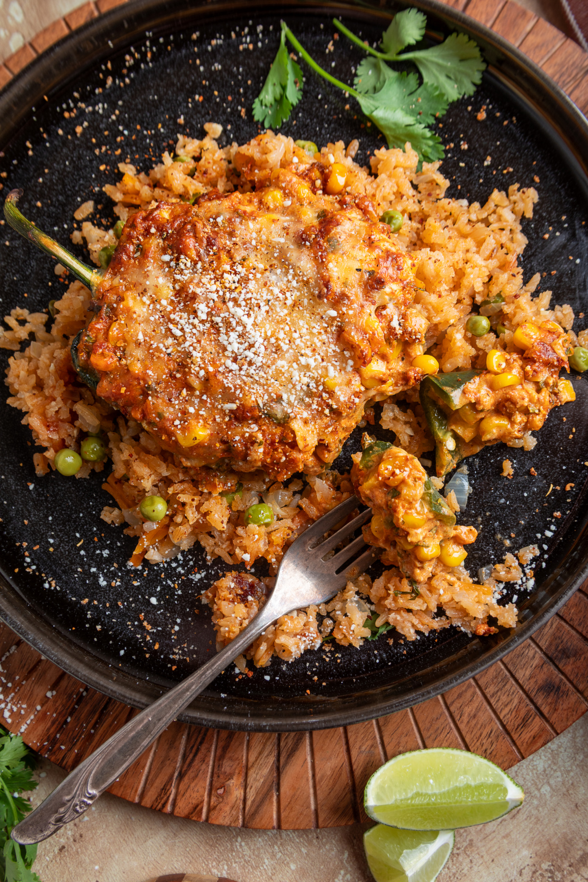 Cheesy chorizo and corn stuffed poblano pepper topped with Cotija and Tajín and served over Mexican rice