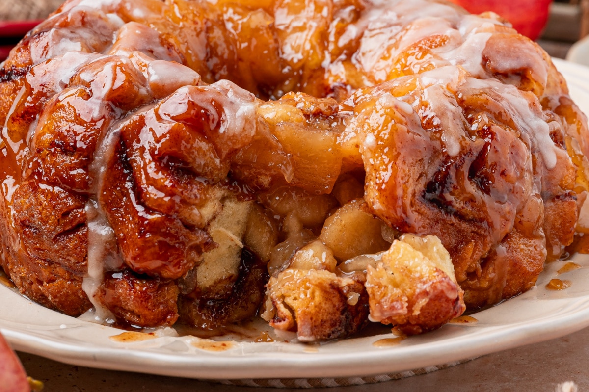 Inside Apple Pie Cinnamon Roll Monkey Bread Apple pie cinnamon roll monkey bread pulled apart to show the baked cinnamon roll center and apple pie filling.