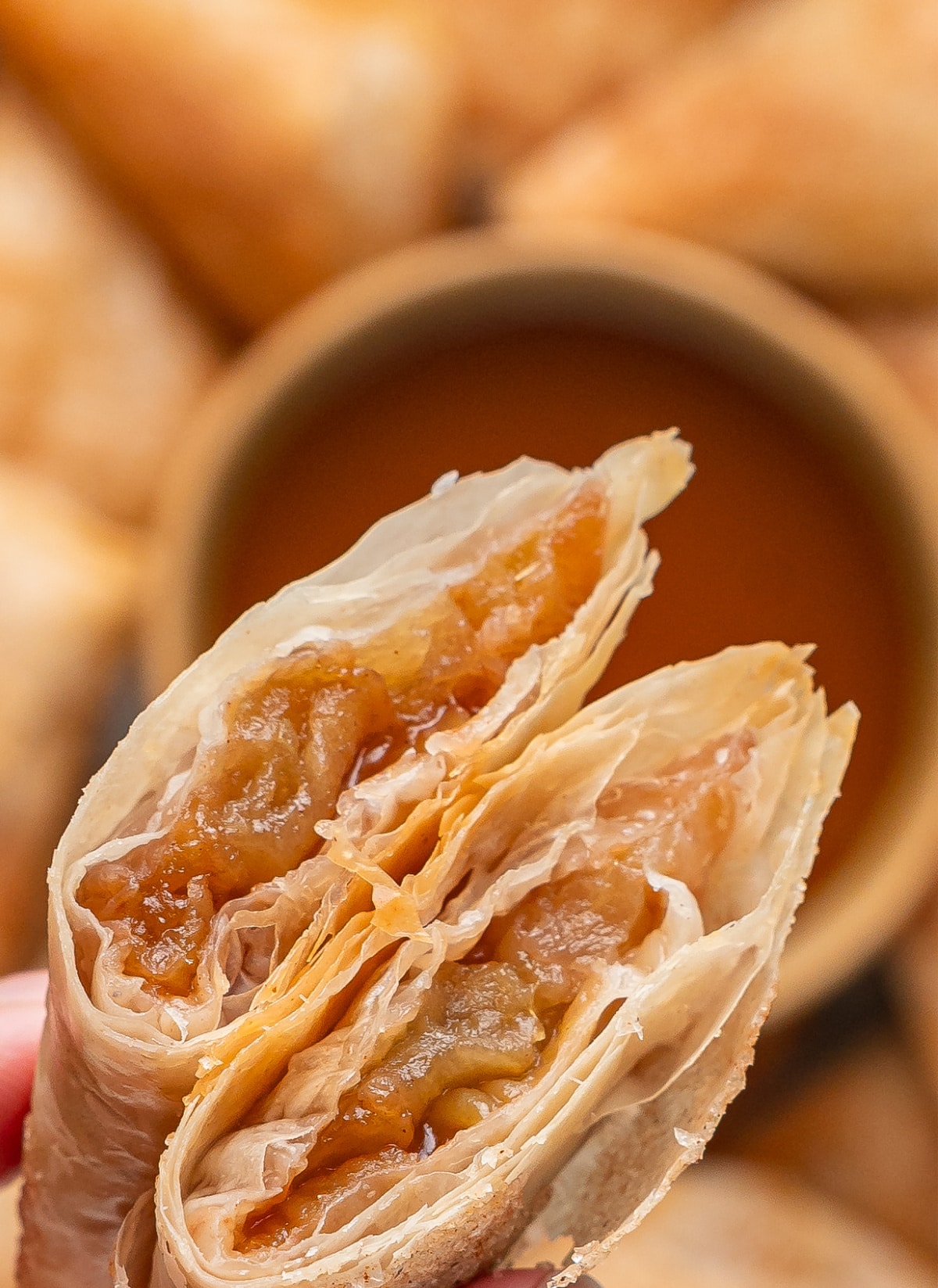 Apple Filling Inside Apple Pie Samosas Apple pie samosa broken open to show the spiced Granny Smith apple filling inside crisp layers of phyllo dough.
