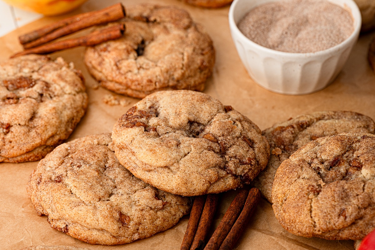 Soft and chewy snickerdoodles with cooked Honeycrisp apples and a cinnamon-sugar coating. Thick apple snickerdoodles with pieces of cinnamon-spiced apple throughout