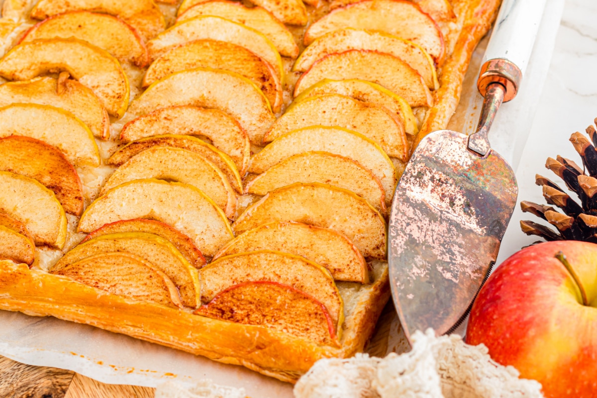 Baked apple tart with overlapping cinnamon apples and a flaky golden puff pastry crust