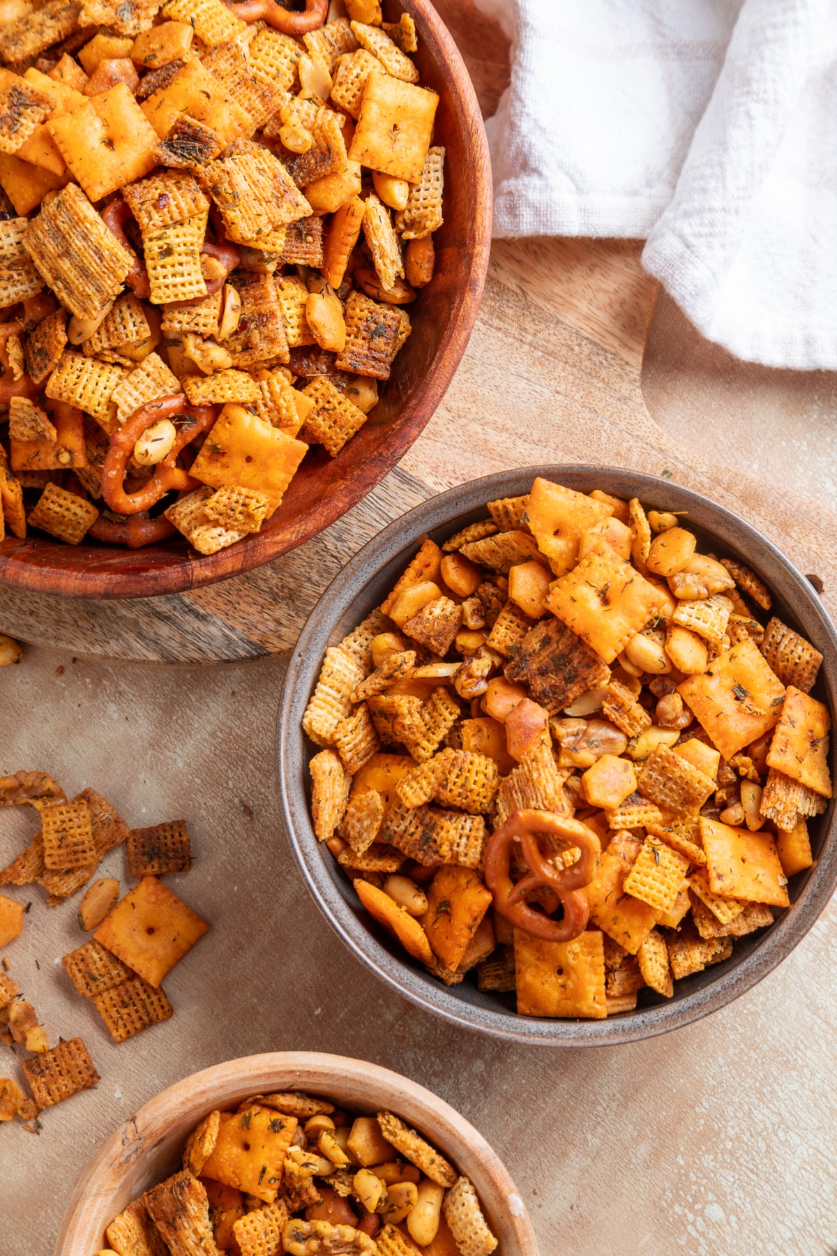 Baked Chex mix with crackers, pretzels, peanuts and walnuts coated in buttery herbs and lemon. Bowls of Chex cereal, Cheez-It crackers, pretzels and nuts baked with cowboy butter seasoning