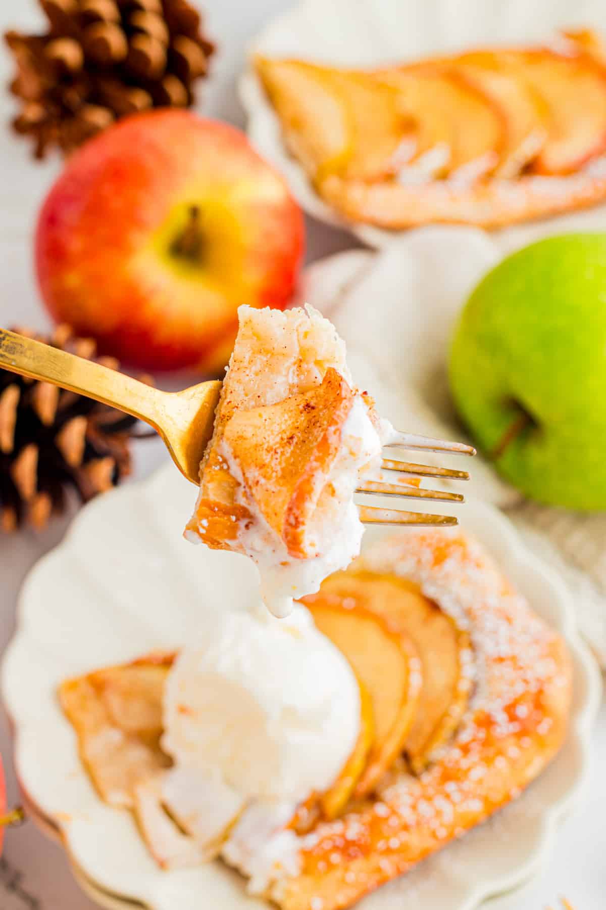 Bite of puff pastry apple tart with cinnamon apple and vanilla ice cream
