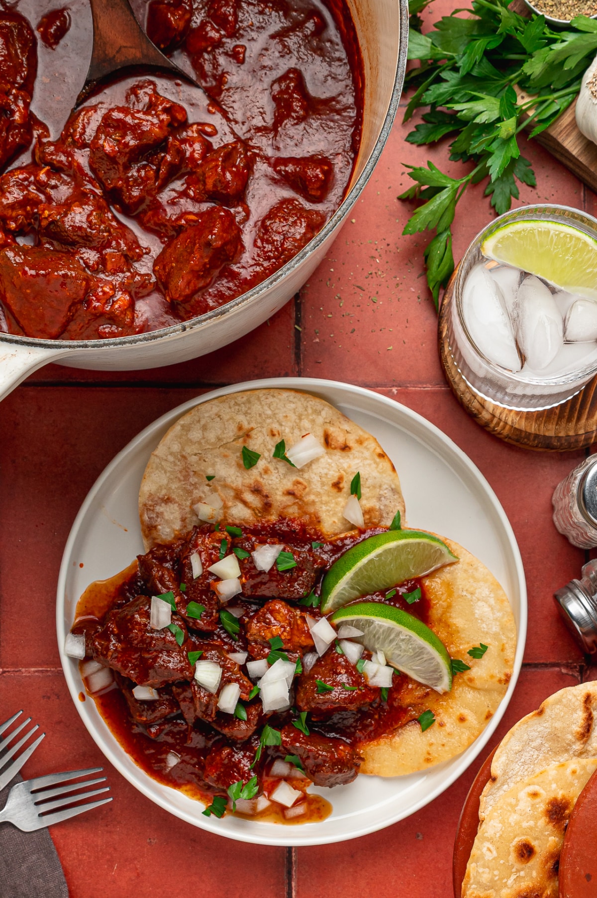 Carne Adovada with Warm Tortillas and Lime Carne adovada served over warm tortillas with chopped onion, parsley and lime