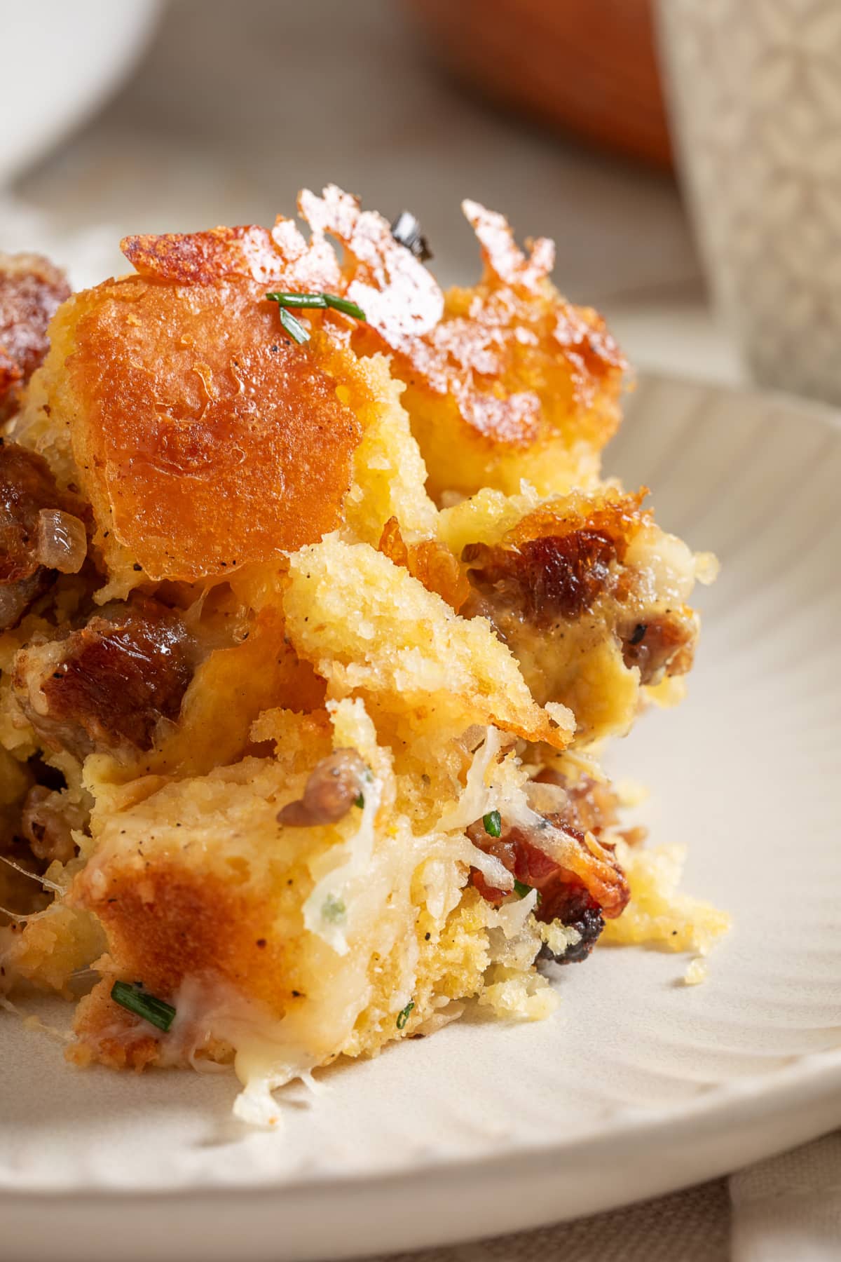 Plated cornbread breakfast casserole with browned cornbread and sausage Plated leftover cornbread breakfast casserole with browned cornbread, sausage and melted cheese