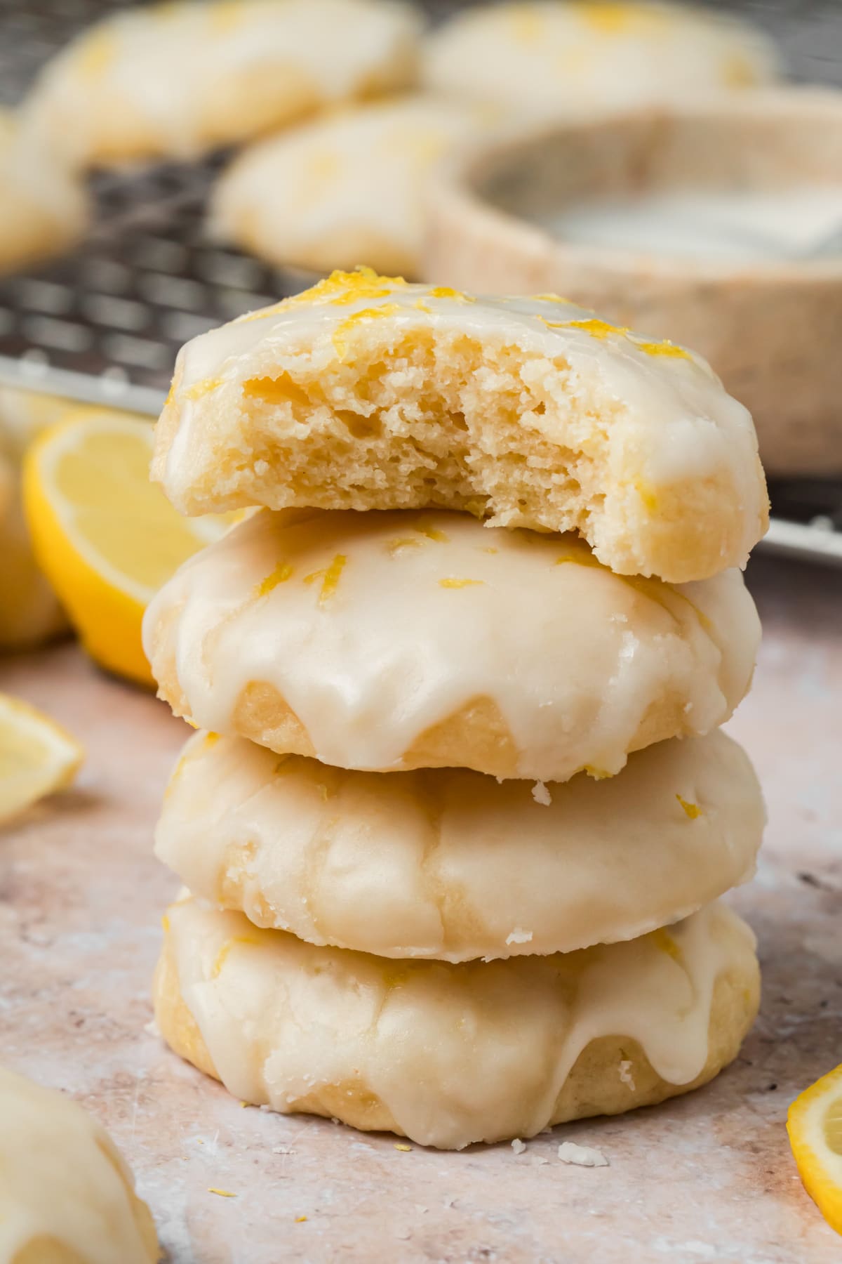 Soft Lemon Ricotta Cookies with Fresh Lemon Glaze Lemon ricotta cookies with fresh lemon glaze stacked with one cookie cut open
