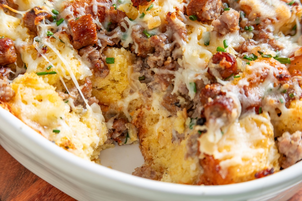 Large cornbread pieces with ground sausage, sliced sausage and melted cheese Inside of cornbread breakfast casserole showing large cornbread pieces, two kinds of sausage and melted cheese