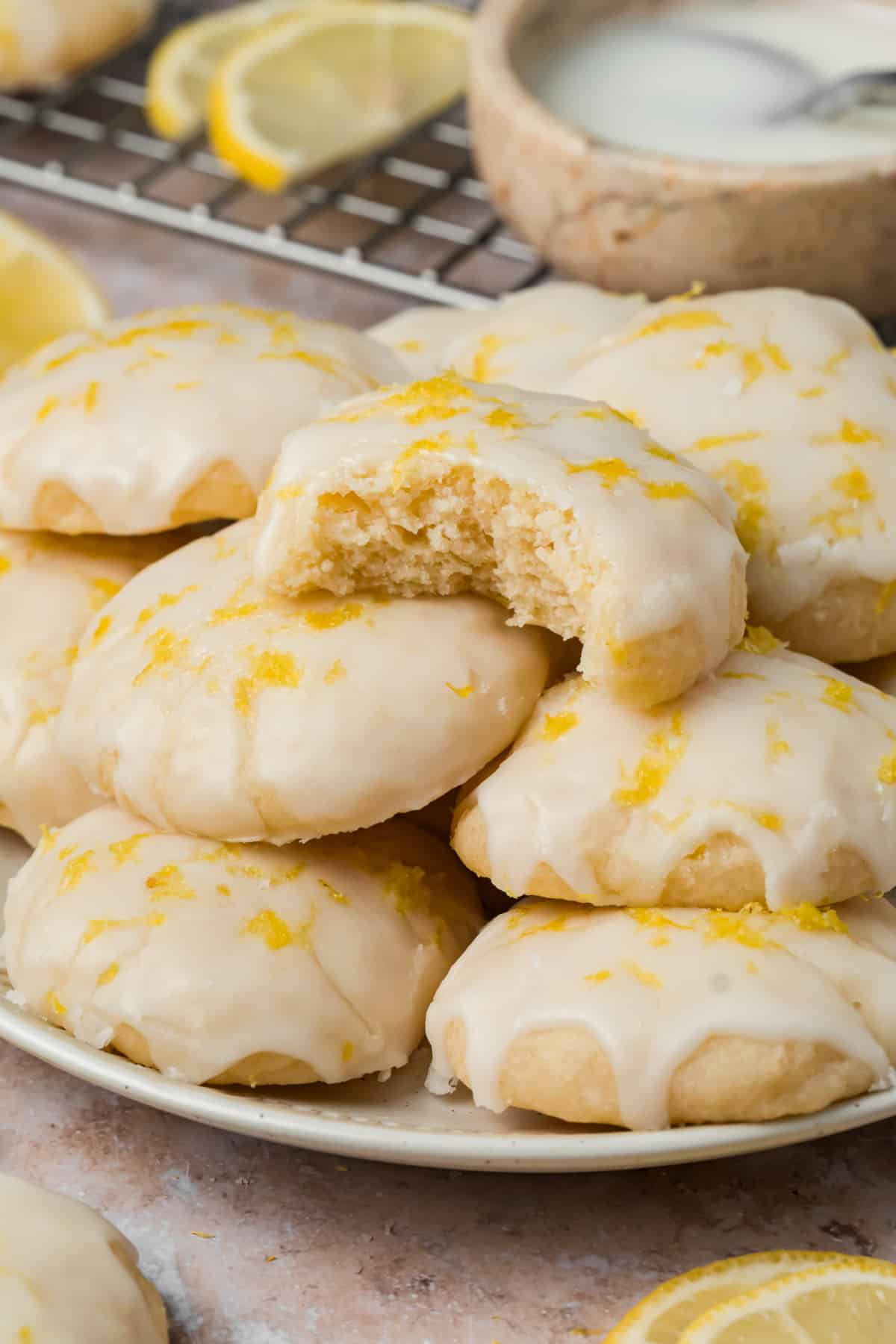 Soft Ricotta Cookies with Lemon Glaze Soft ricotta cookies with lemon glaze and fresh zest with one cookie broken open to show the center